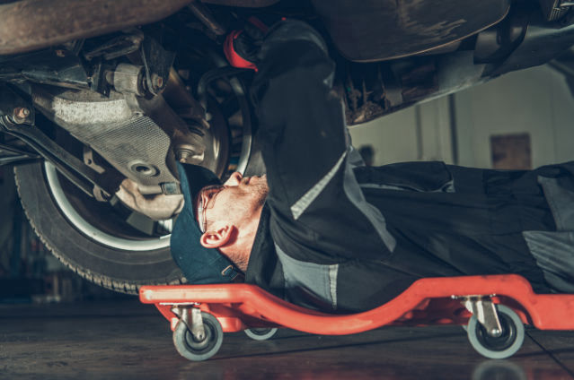 mechanic working under a car